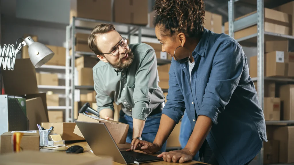 Small business team using technology to automate inventory and order processing, boosting efficiency, saving time, and reducing manual errors with Scorpion Five Technologies solutions.