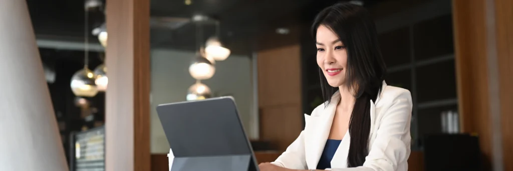 Small business owner using cloud technology at a laptop in a modern workspace—capturing how Scorpion Five Technologies supports growth with small business technology, web development, digital marketing, and custom software services.