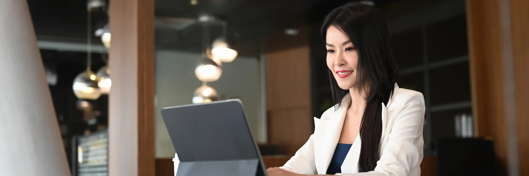 Small business owner using cloud technology at a laptop in a modern workspace—capturing how Scorpion Five Technologies supports growth with small business technology, web development, digital marketing, and custom software services.