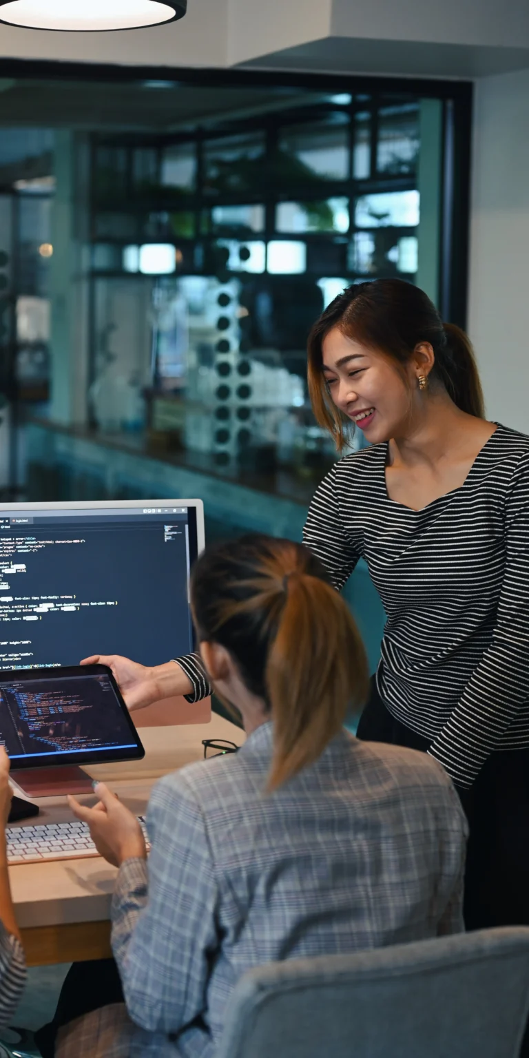 Team of developers collaborating on responsive website code—illustrating how Scorpion Five Technologies provides small businesses with expert web development solutions optimized for all devices.