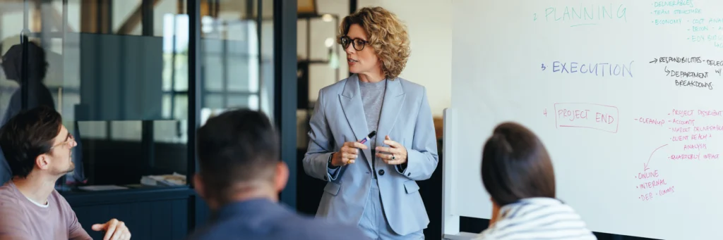 Project leader guiding a modernization strategy session—illustrating how Scorpion Five Technologies (S5T) delivers measured, phased legacy system modernization for large organizations and government agencies.